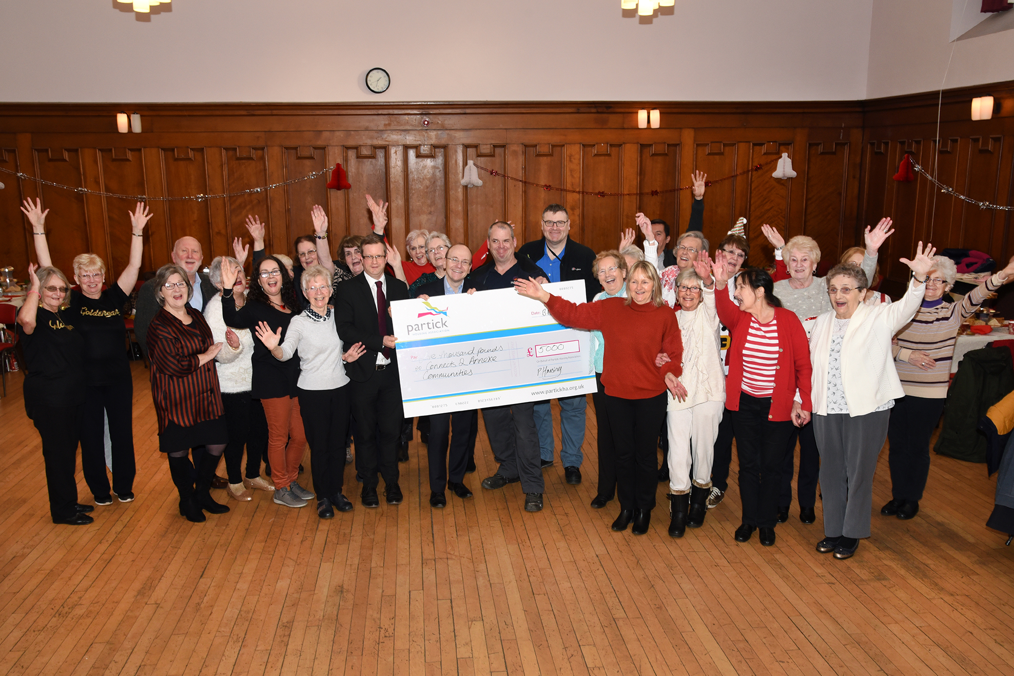 Partick Housing Association and partners present cheque for £5,000 at